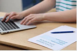 student writing scholarship acceptance letter email laptop 2026